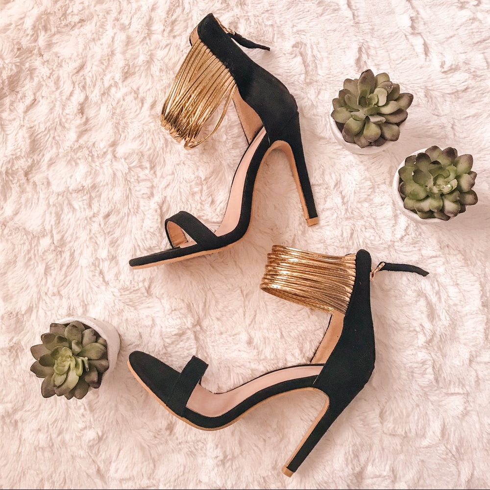 Open toe black stilettos with gold straps